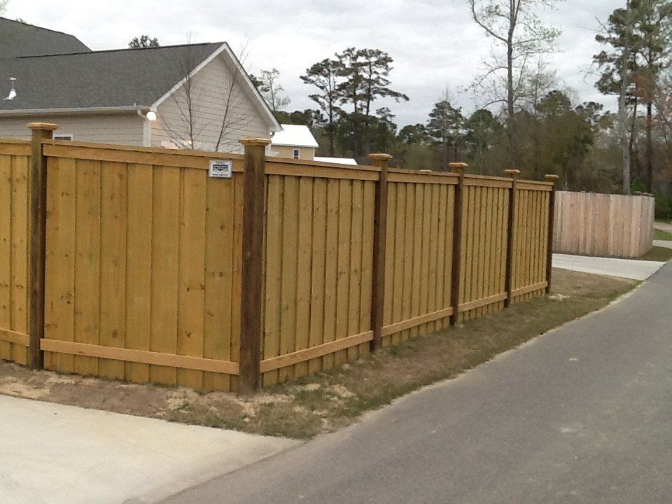 A wooden fence along the side of a road