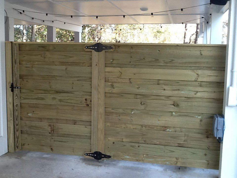 A wooden fence is sitting under a white roof