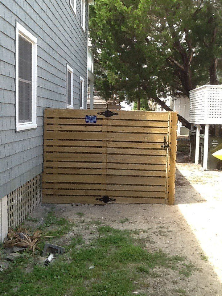 A house with a wooden gate in front of it