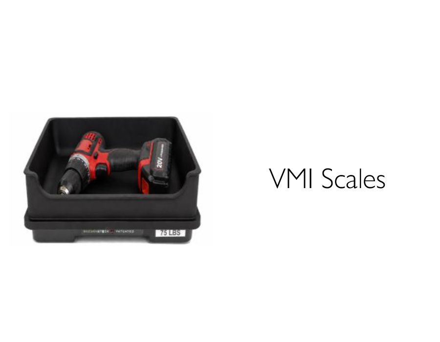 Black tray holding two red-and-black VMI Scales devices on a white background