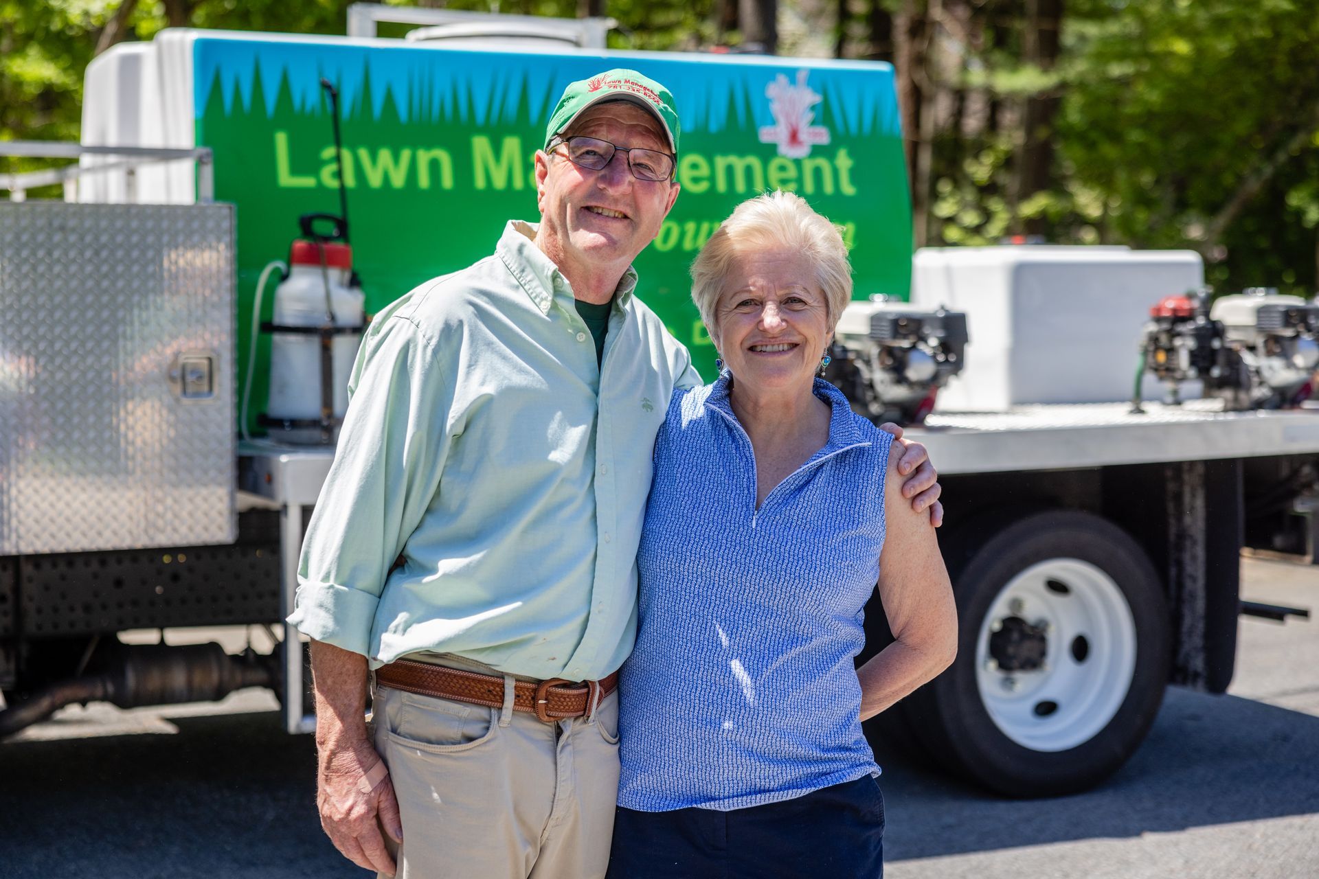 Man and woman stand next to a truck with 