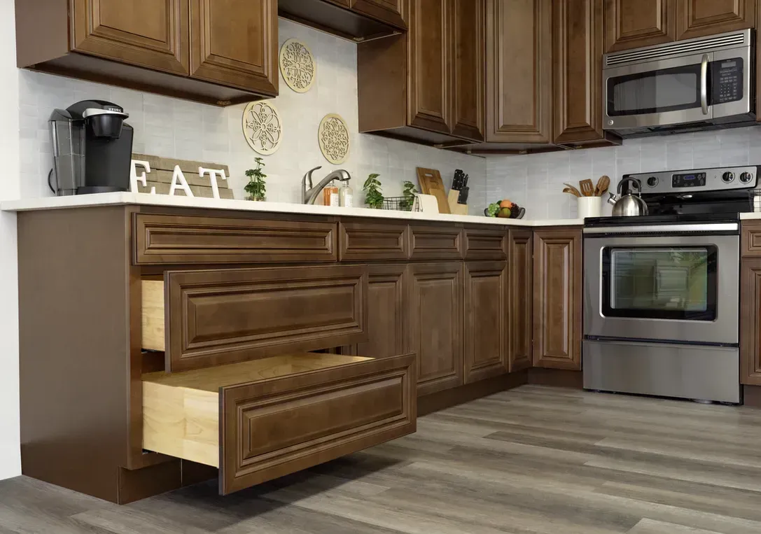 A kitchen corner features dark wood cabinets with two open drawers, a stove, a microwave, and a white tiled backsplash.