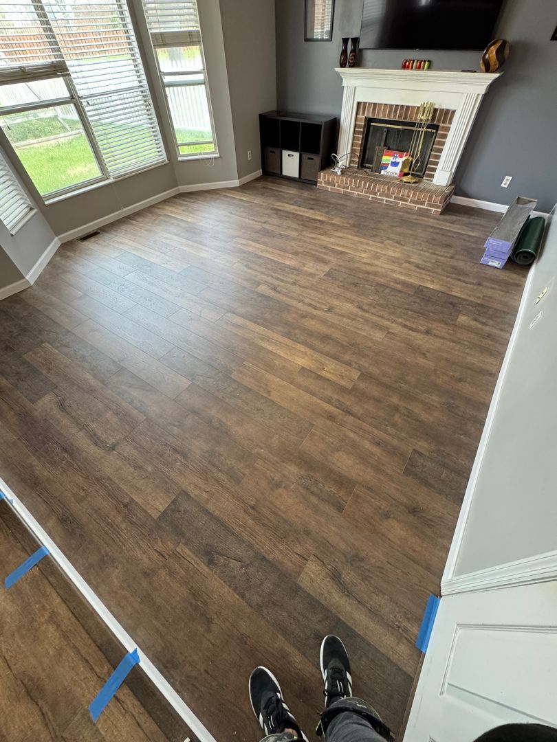 A living room with hardwood floors and a fireplace.