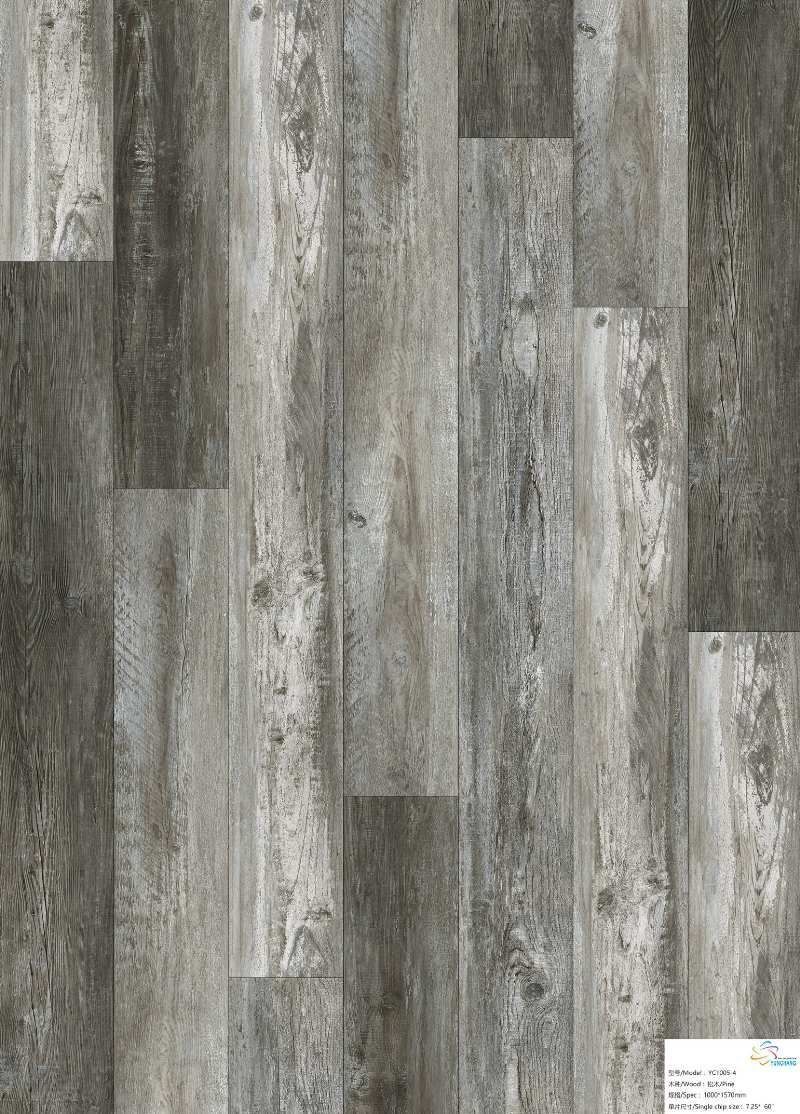 A close up of a gray wooden floor with a white label on it.