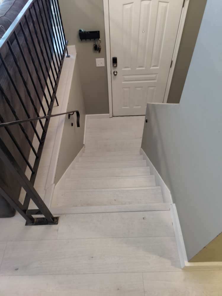 The stairs are painted white and the railing is black