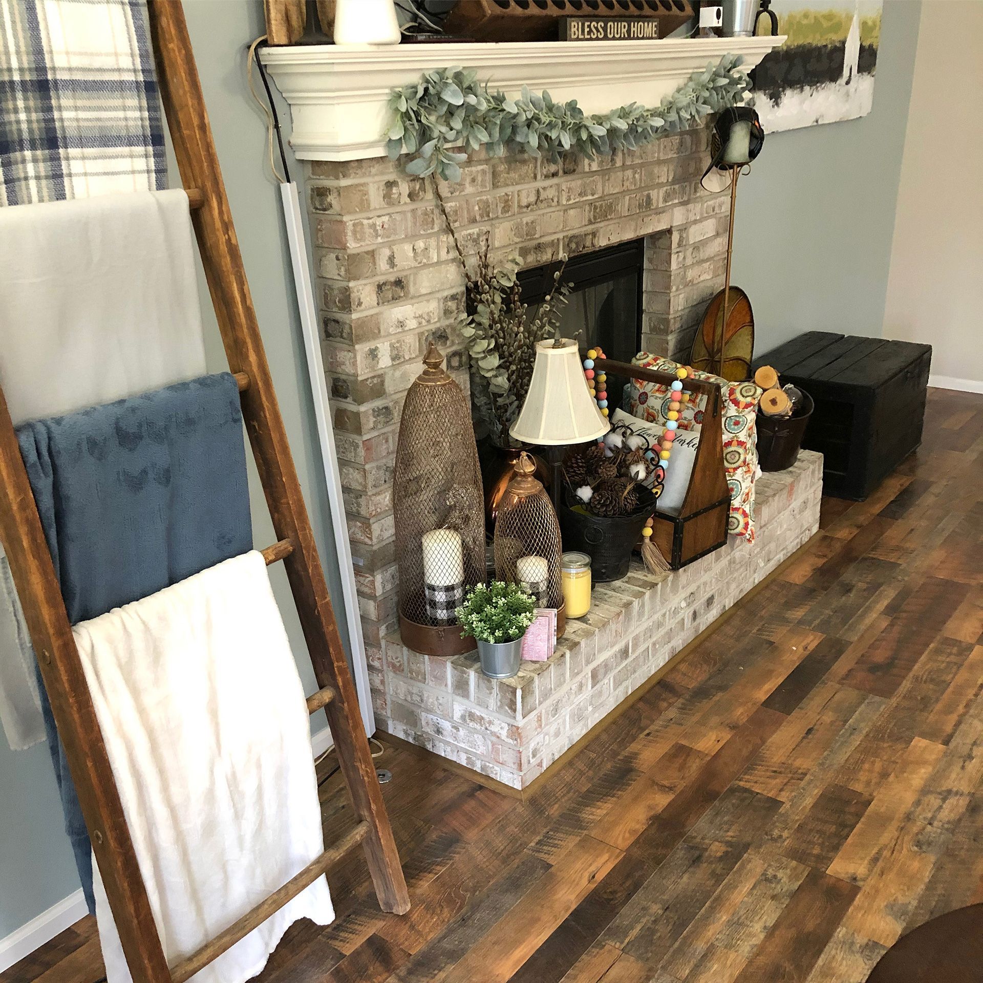A living room with a fireplace and a wooden towel rack