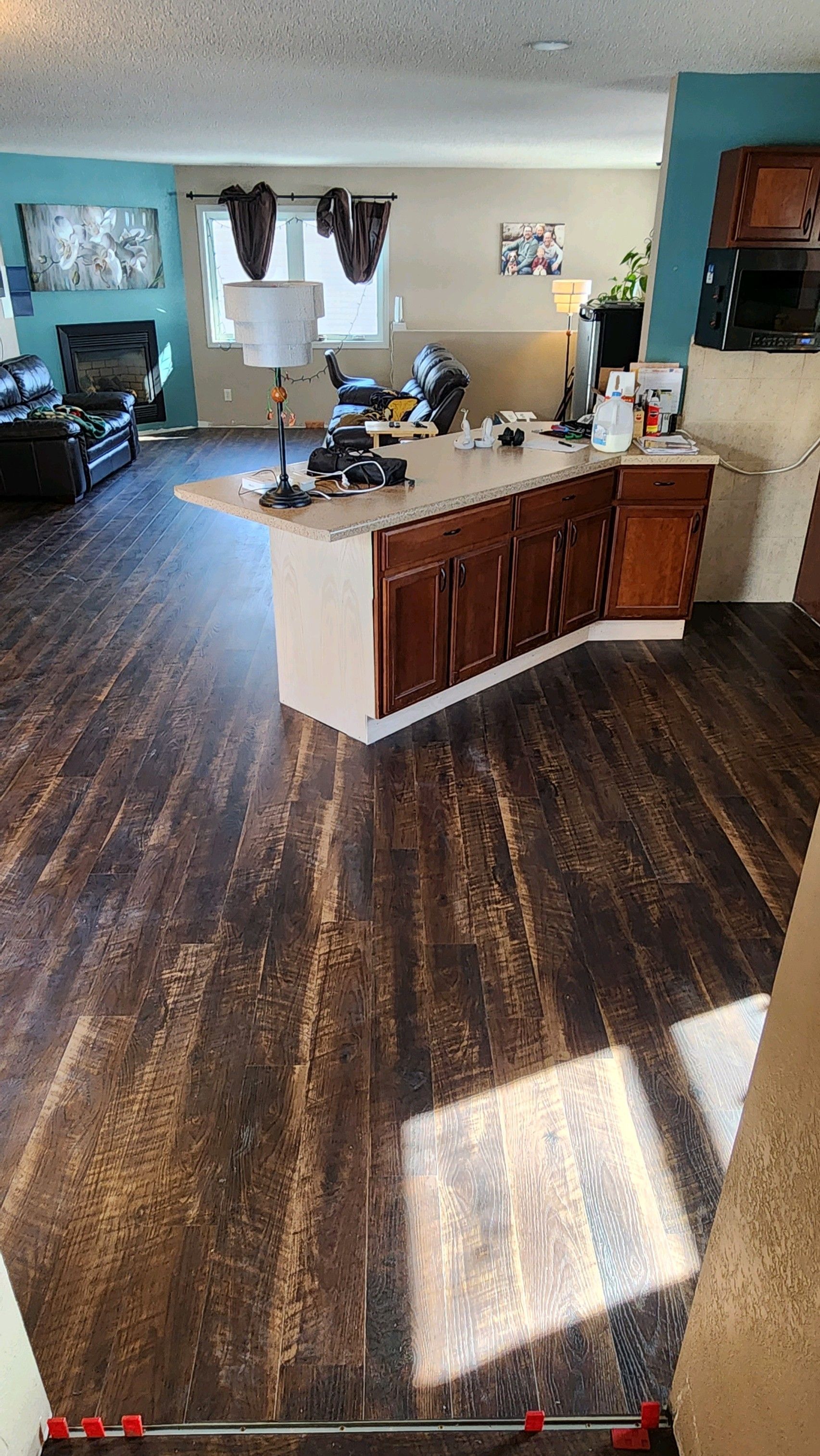 A kitchen with a large island in the middle of the room and hardwood floors