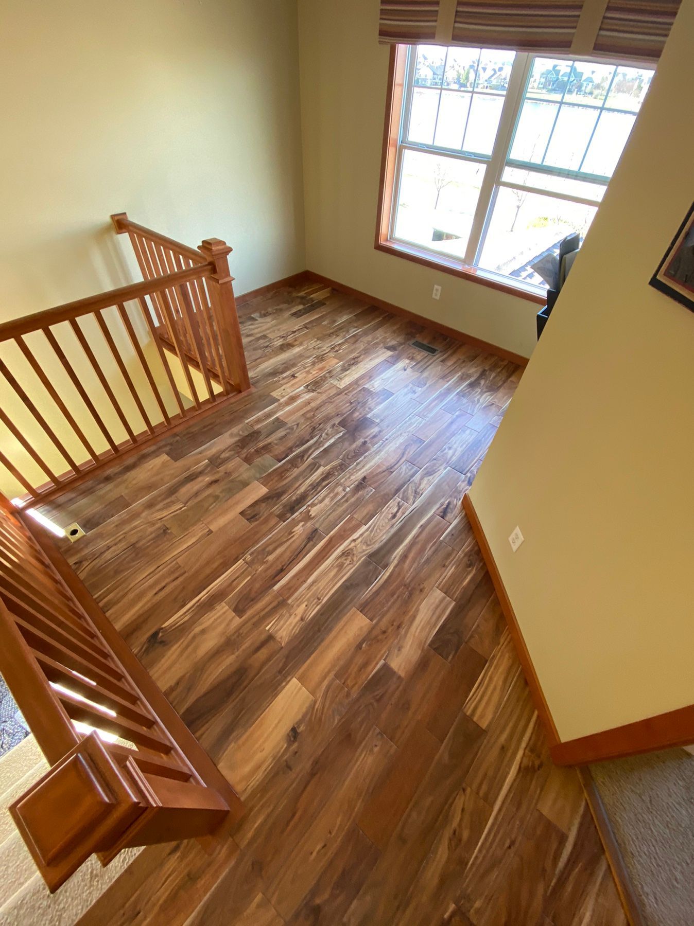 An aerial view of a living room with hardwood floors and stairs