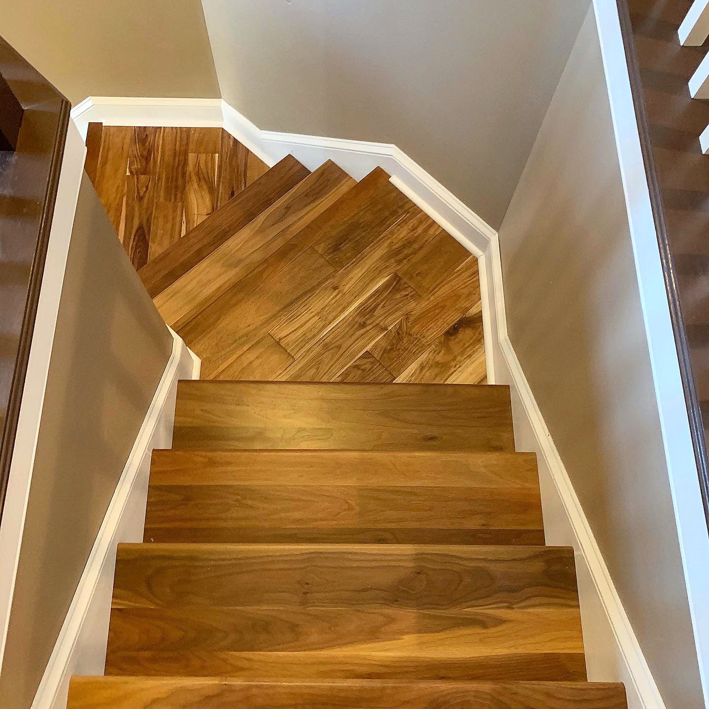 A staircase with wooden steps and a white railing