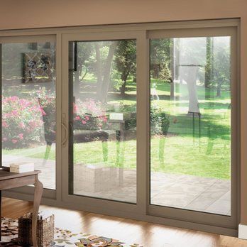 A living room with sliding glass doors leading to a patio