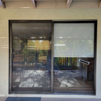 Sliding glass door with a blind on it