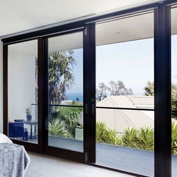 A bedroom with sliding glass doors leading to a balcony