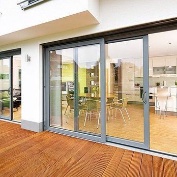 A house with sliding glass doors and a wooden deck