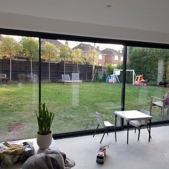 A living room with sliding glass doors leading to a backyard with a playground