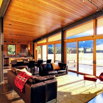 A living room with a lot of windows and a couch