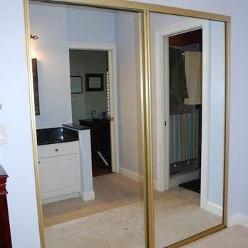 A bedroom with a sliding glass door leading to a bathroom