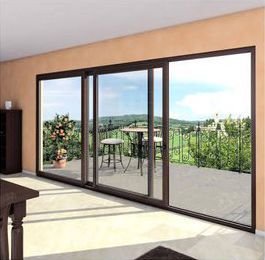 A living room with sliding glass doors leading to a balcony with a beautiful view