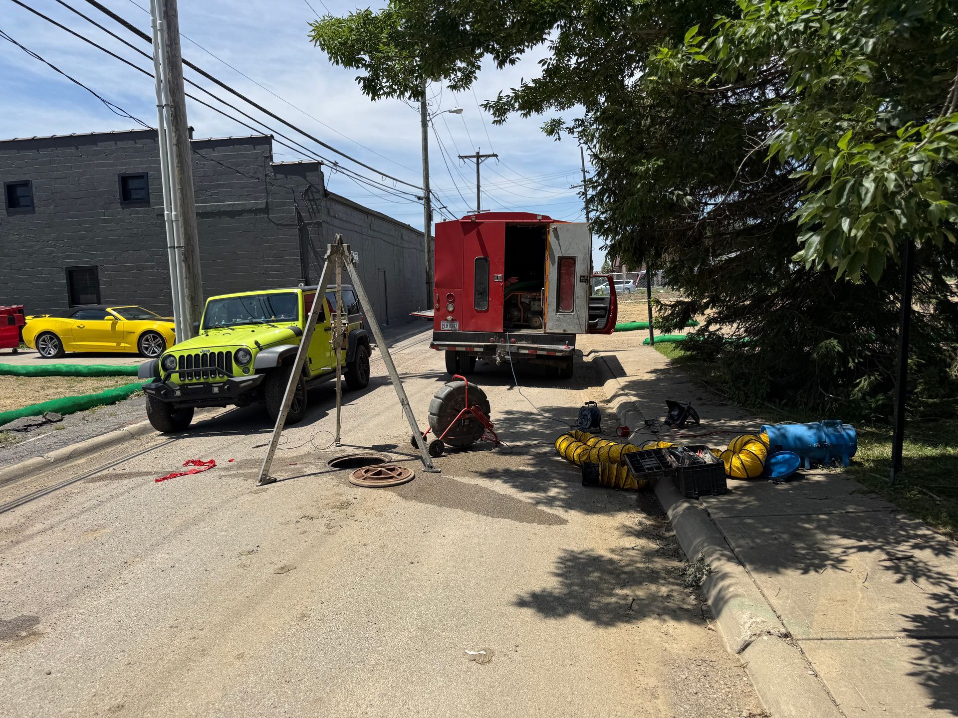 Street scene with emergency vehicles, caution tape, and scattered debris after an incident