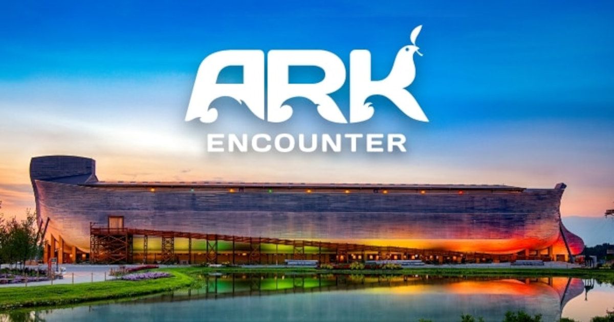 ARK Encounter building at sunset, with lit reflections in water and the logo above.