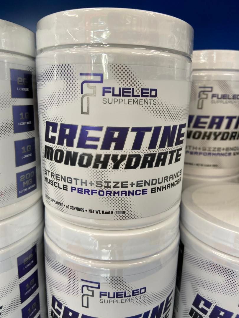 A stack of bottles of creatine monohydrate on a shelf.