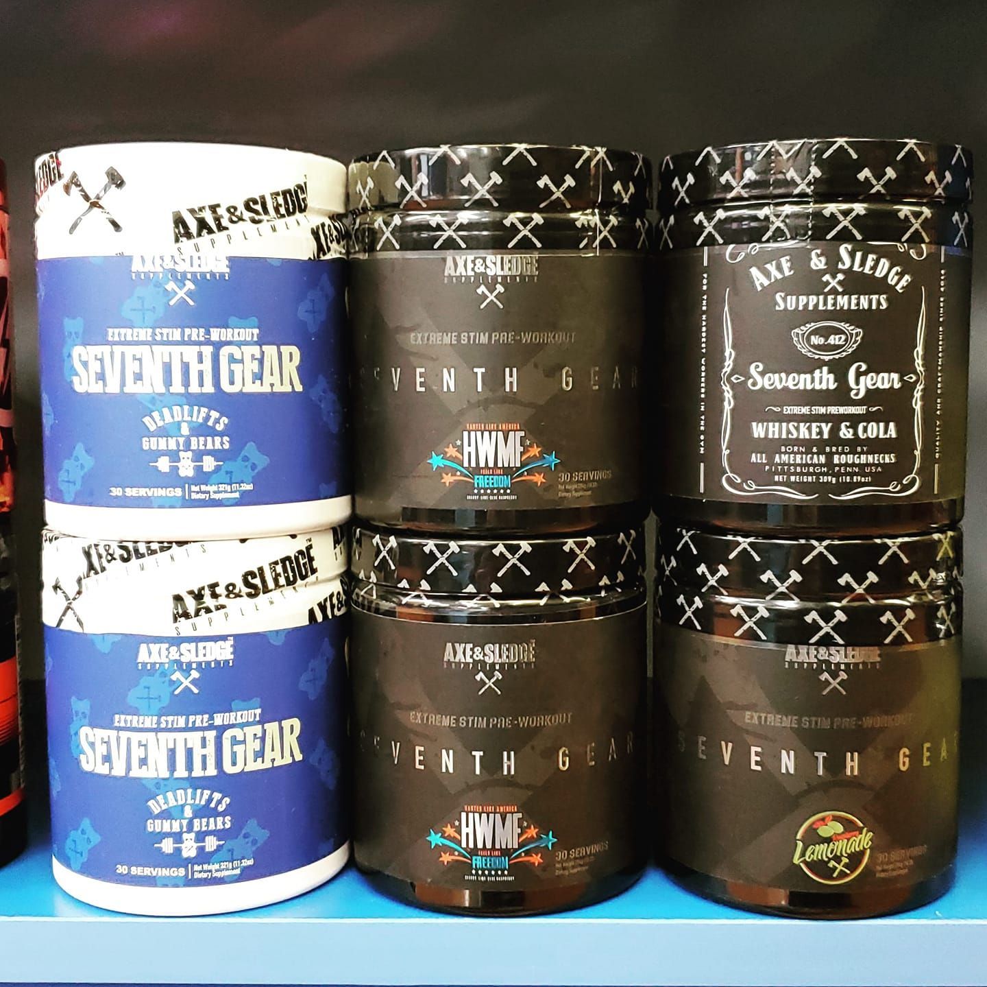 Sports supplements are stacked on top of each other on a shelf.
