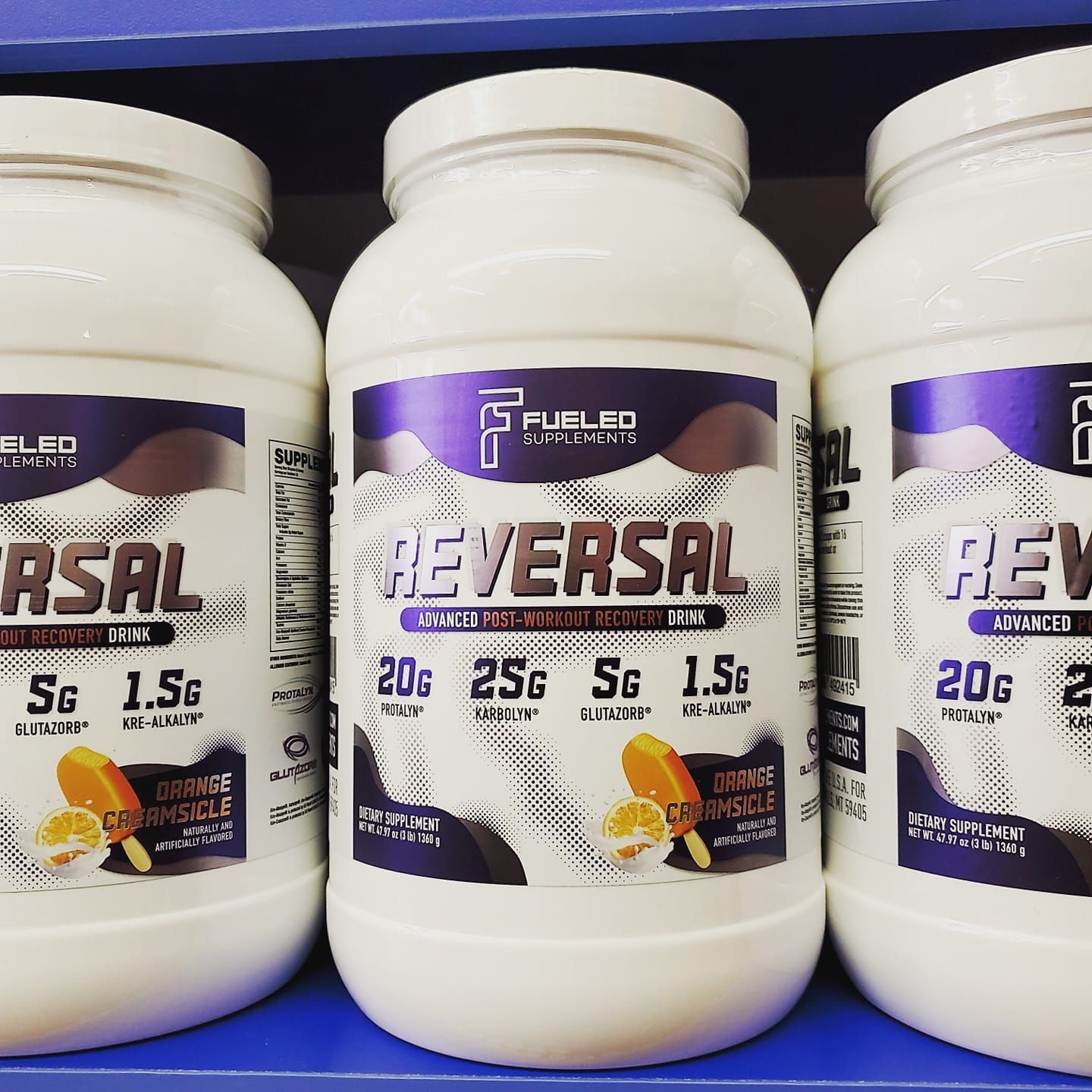 Three bottles of asal and reversal are lined up on a shelf.