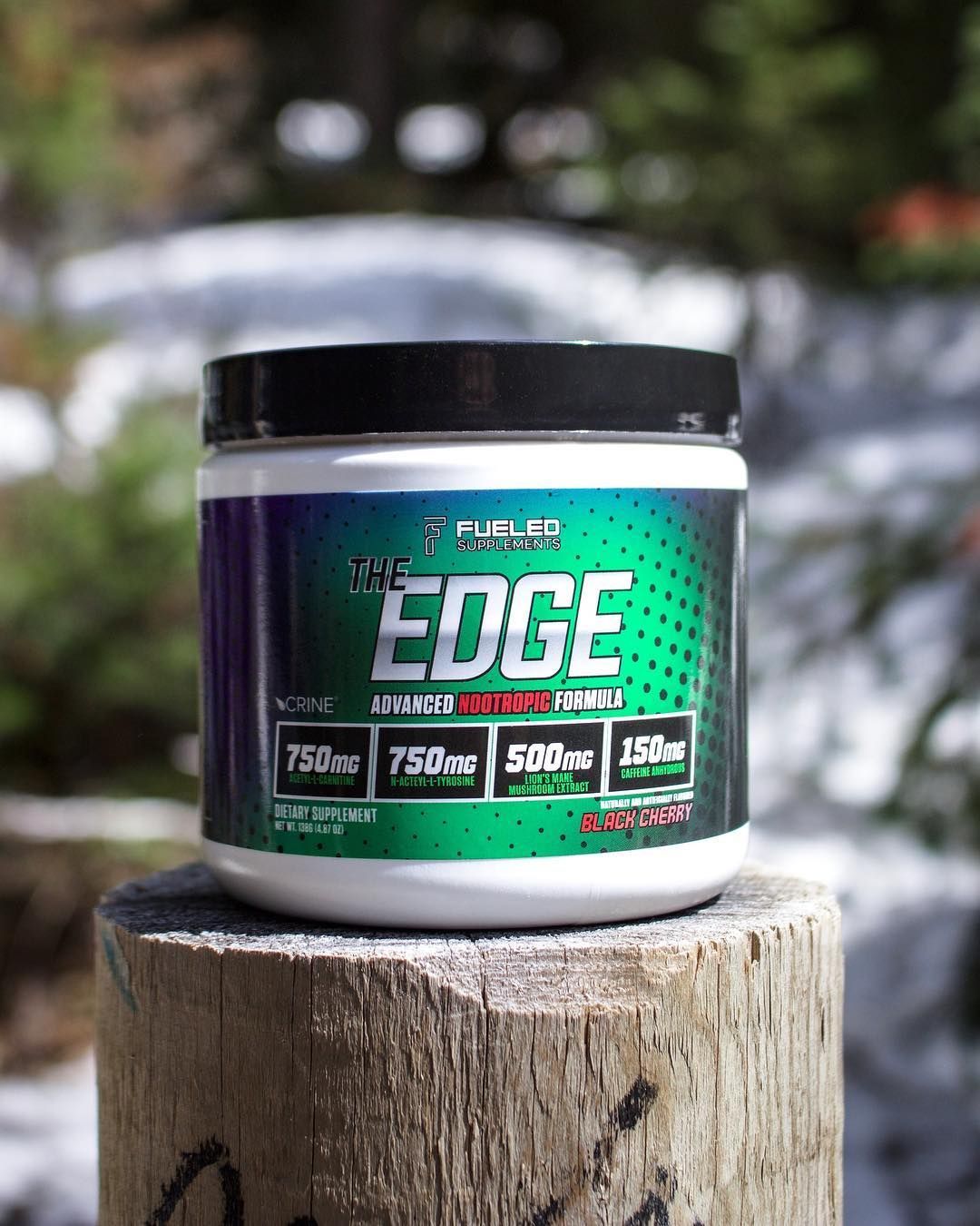 A jar of edge is sitting on top of a wooden post.