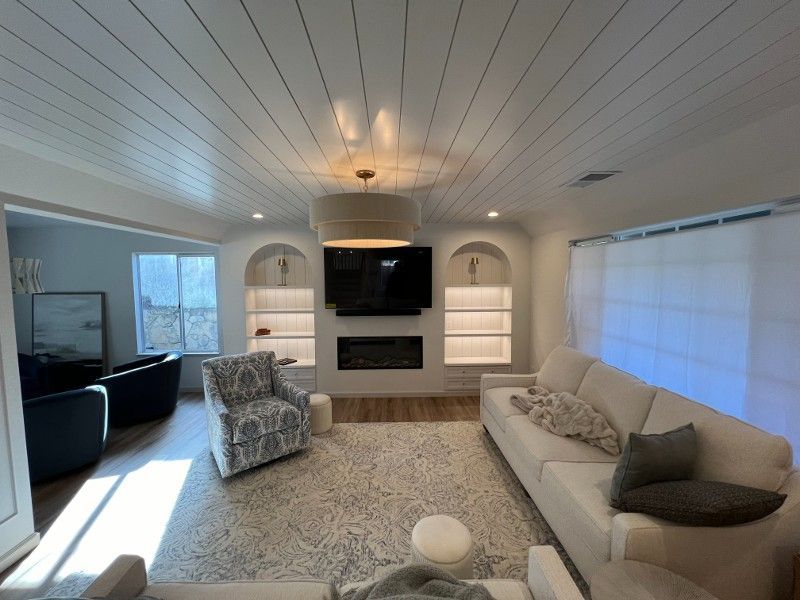 A living room with a couch a chair and a flat screen tv