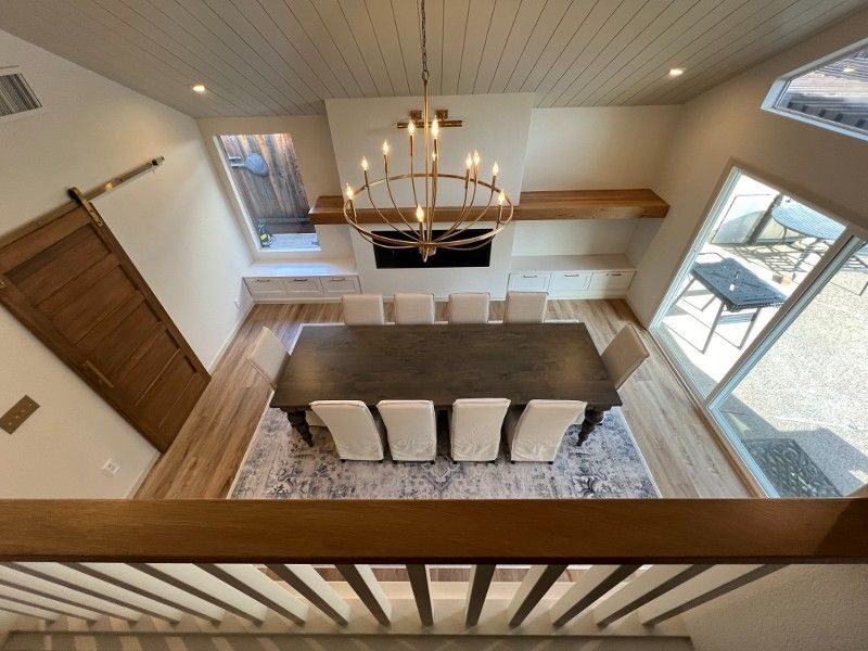 An aerial view of a dining room with a table and chairs