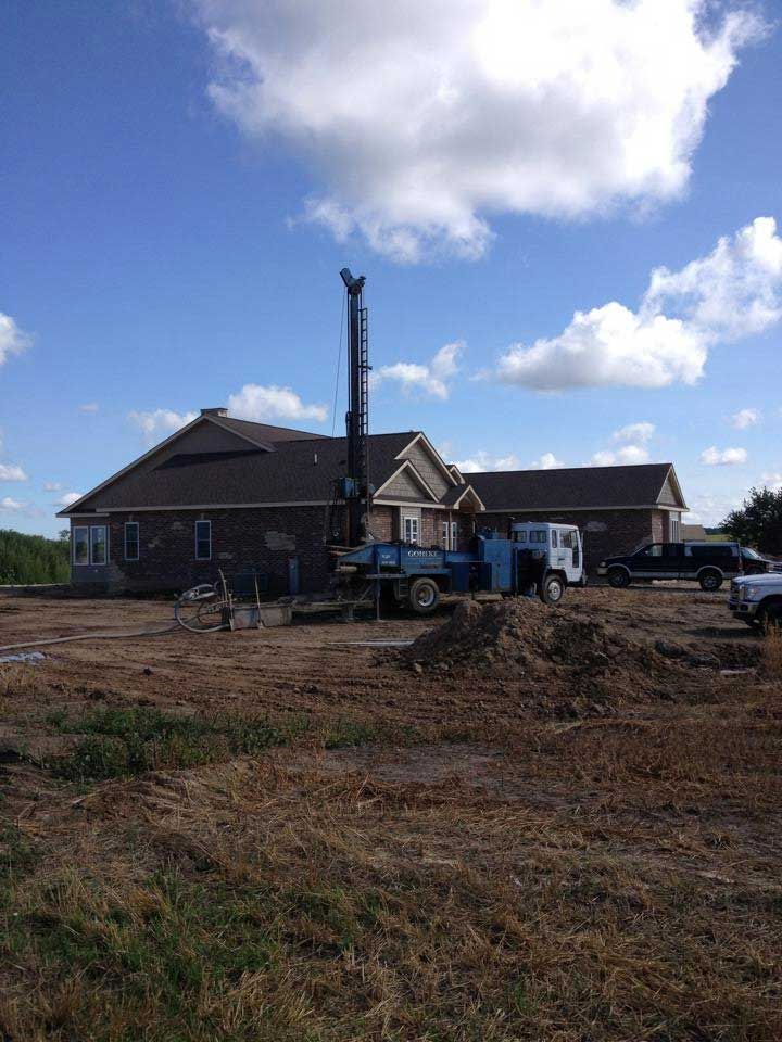 a large blue truck is parked in front of a house