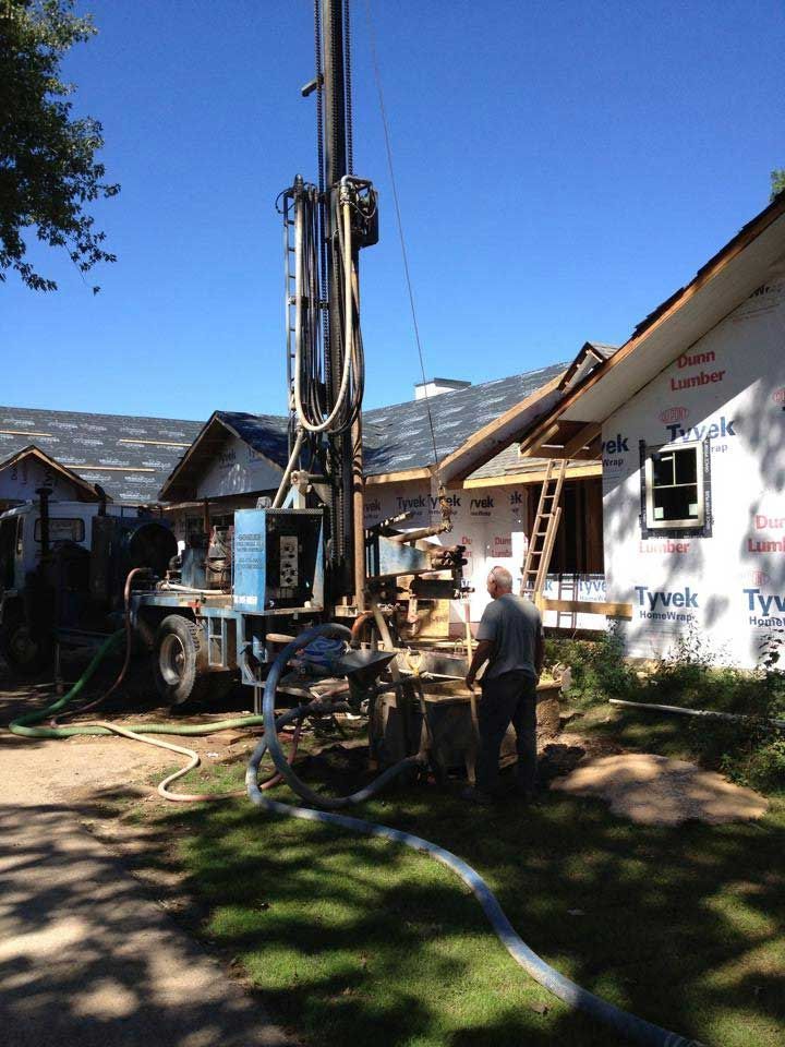 a man is standing in front of a house that is being built