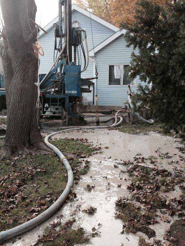 a hose is connected to a machine in front of a house