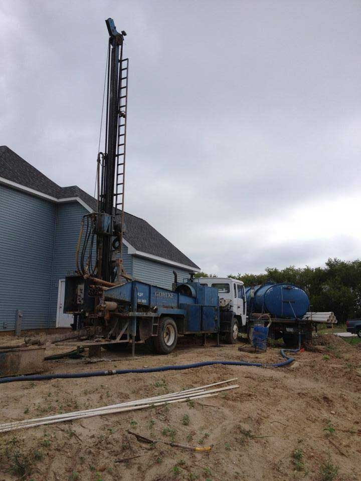 a large blue truck is parked in front of a house