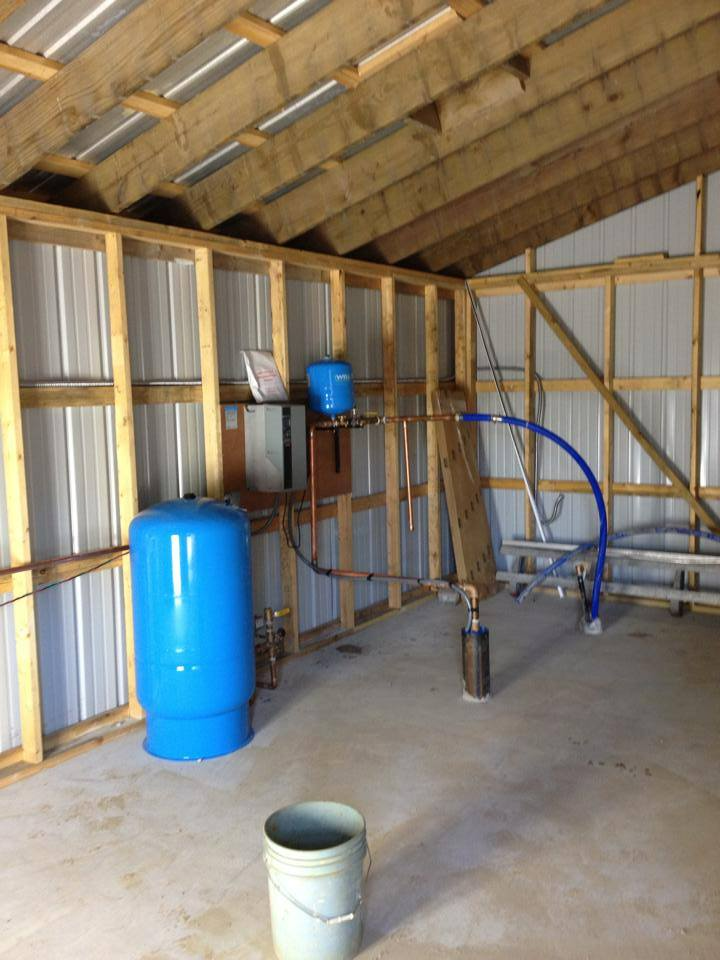 a room with a blue tank and a white bucket