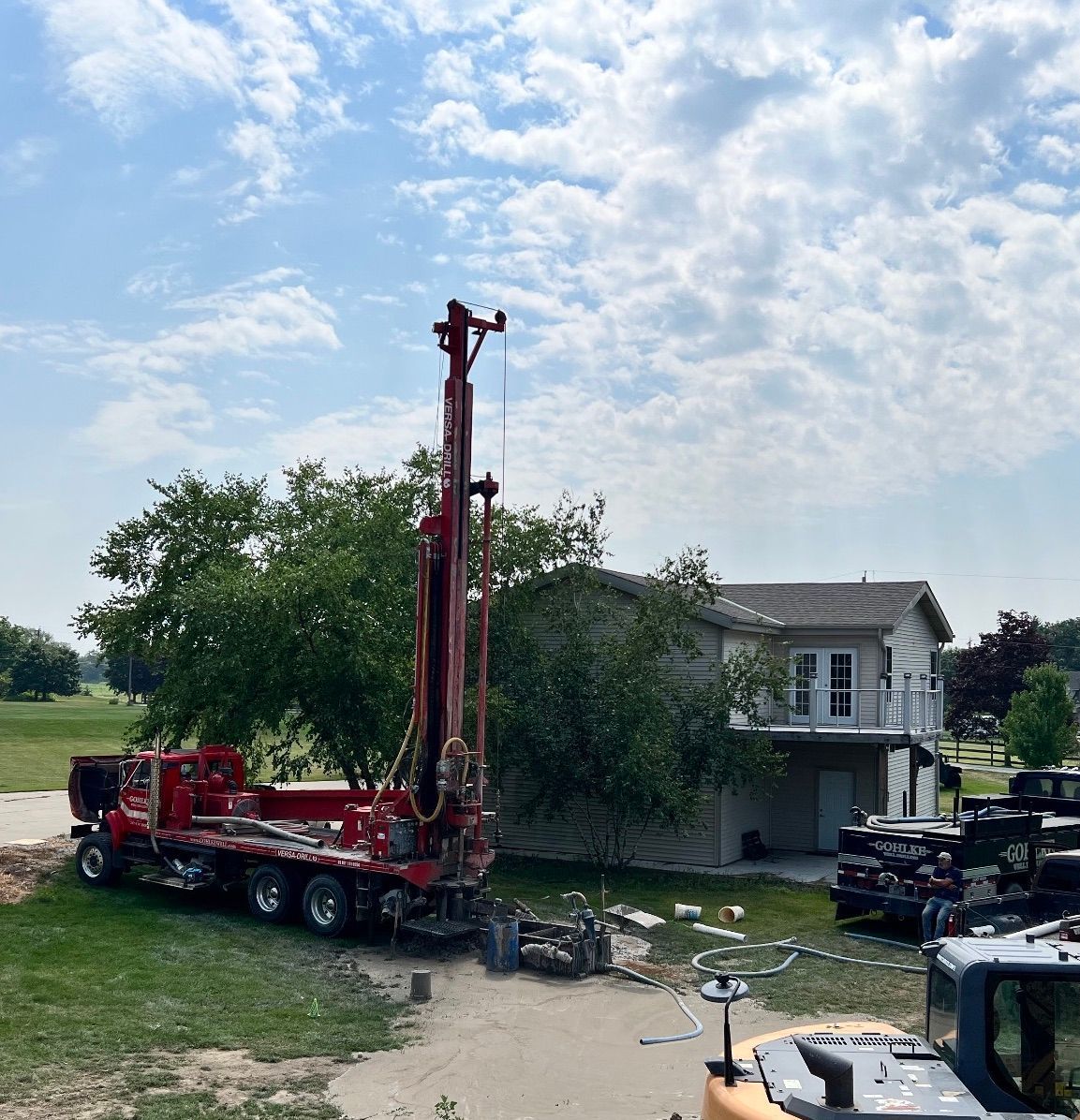 a red truck is parked in front of a house