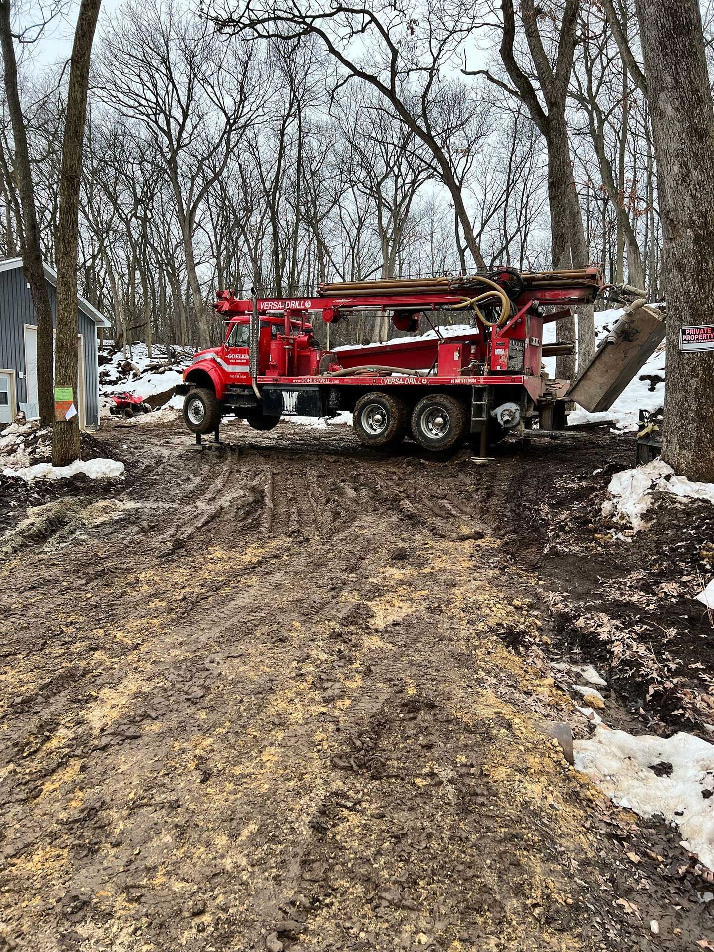 a red truck is parked in the middle of a dirt road