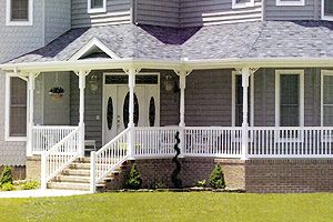 A large house with a porch and stairs.