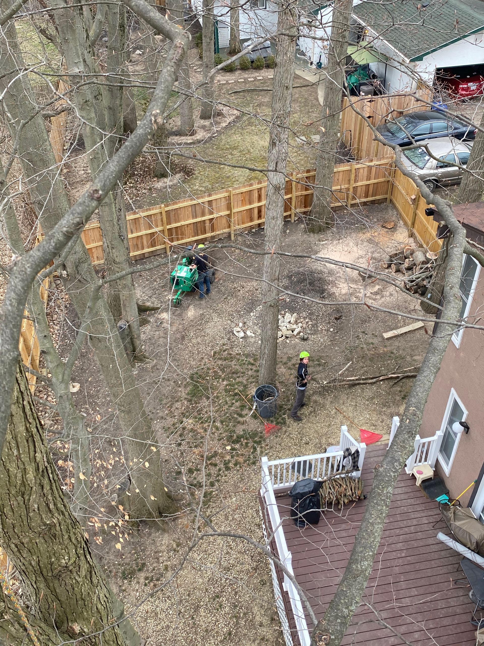 An aerial view of a backyard with a house and a fence.