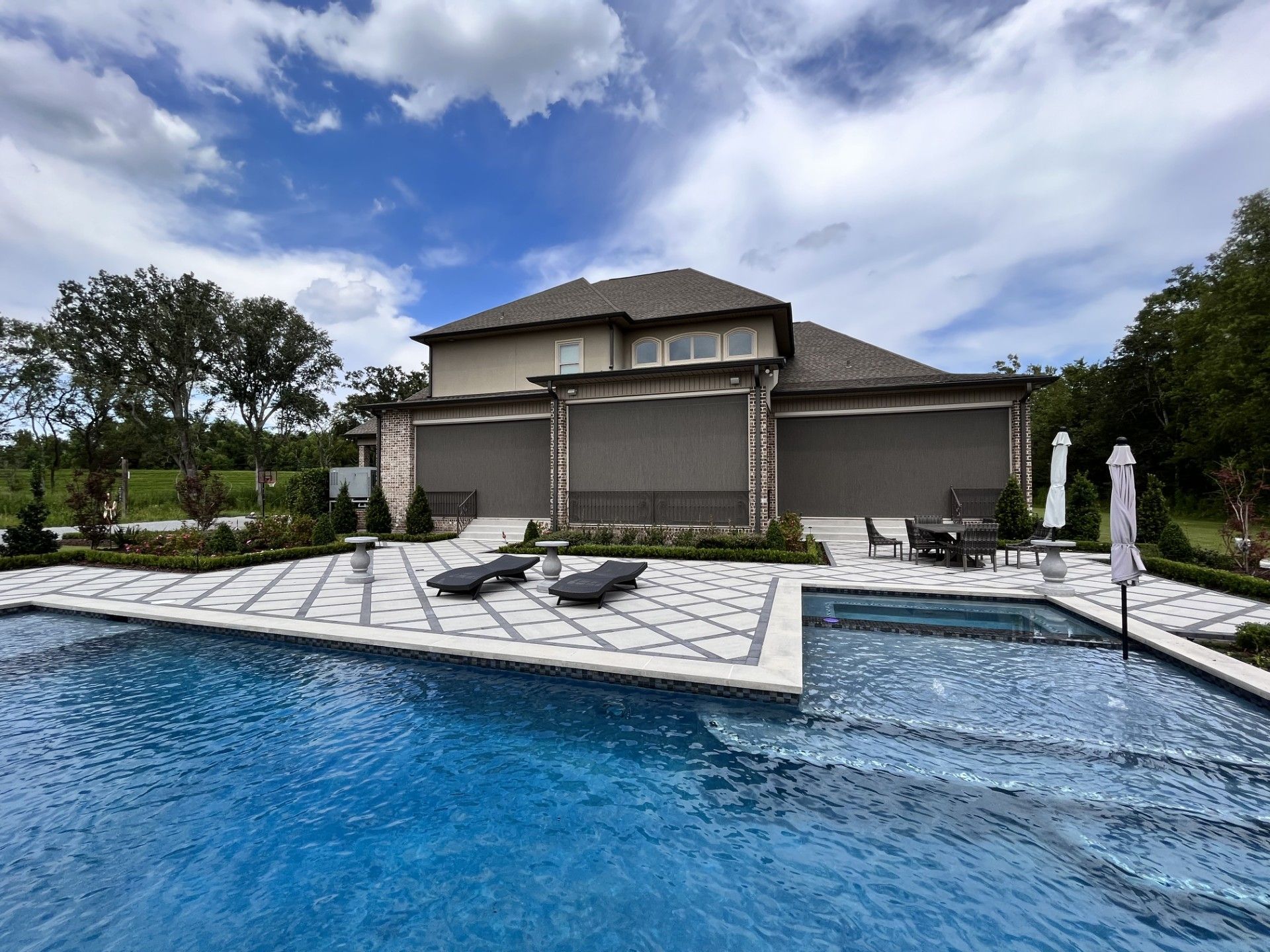 A large house with a large swimming pool in front of it