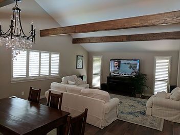 A living room with a couch , table , chairs and a television.