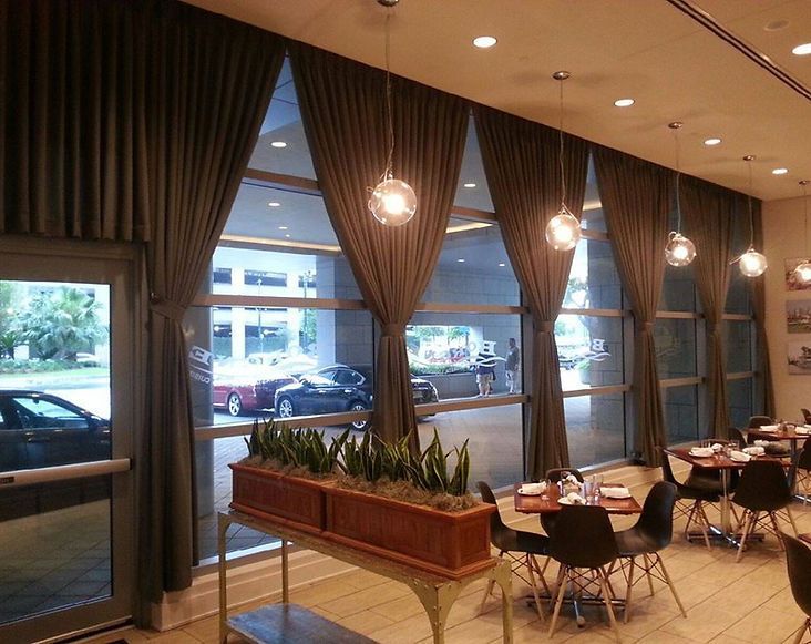 A restaurant with tables and chairs and lots of windows