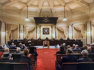 A group of people are sitting in a courtroom.