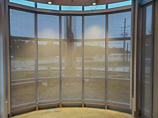 A room with a lot of windows and a curved wall.