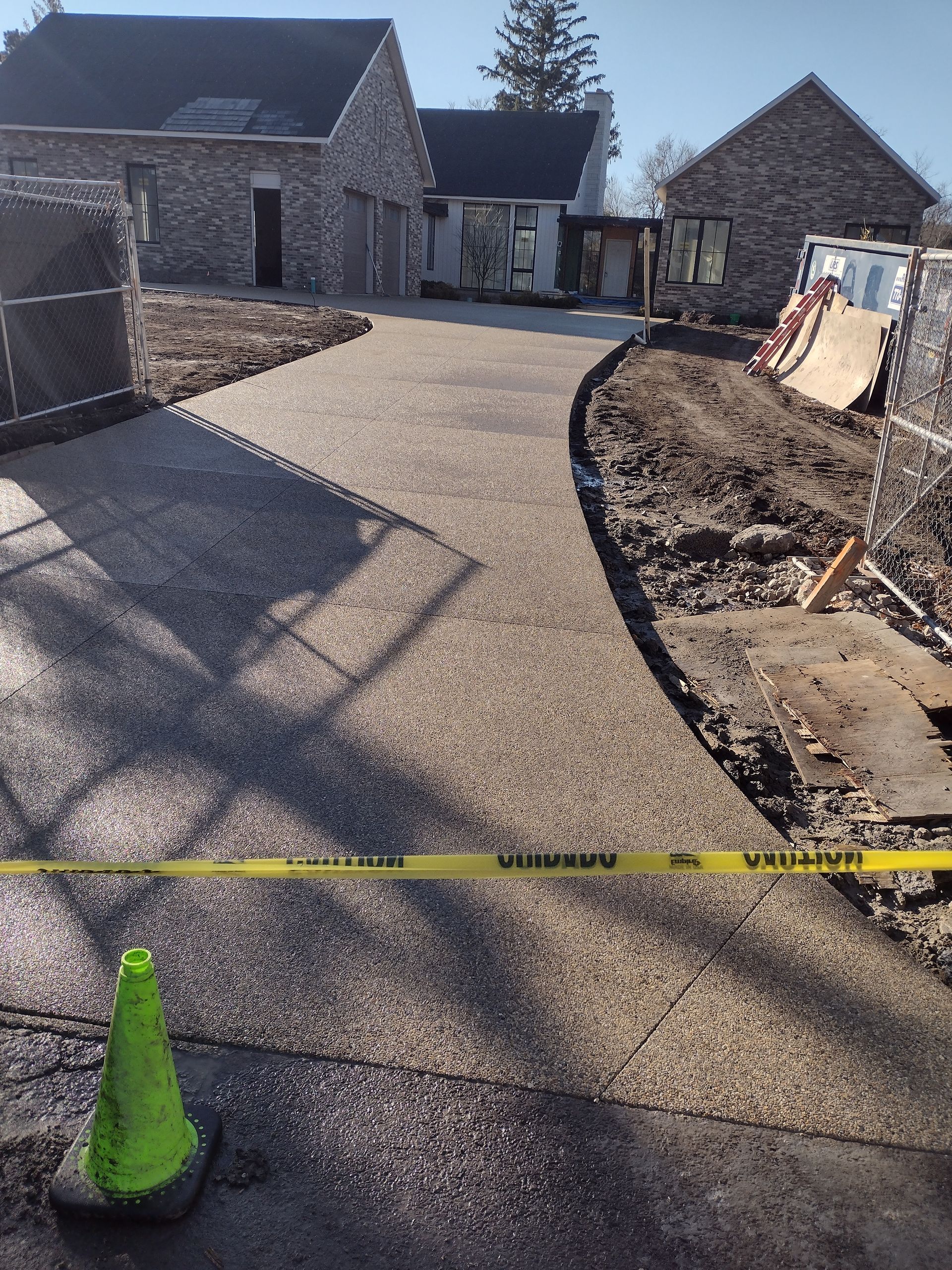 A concrete driveway is being built in front of a house.