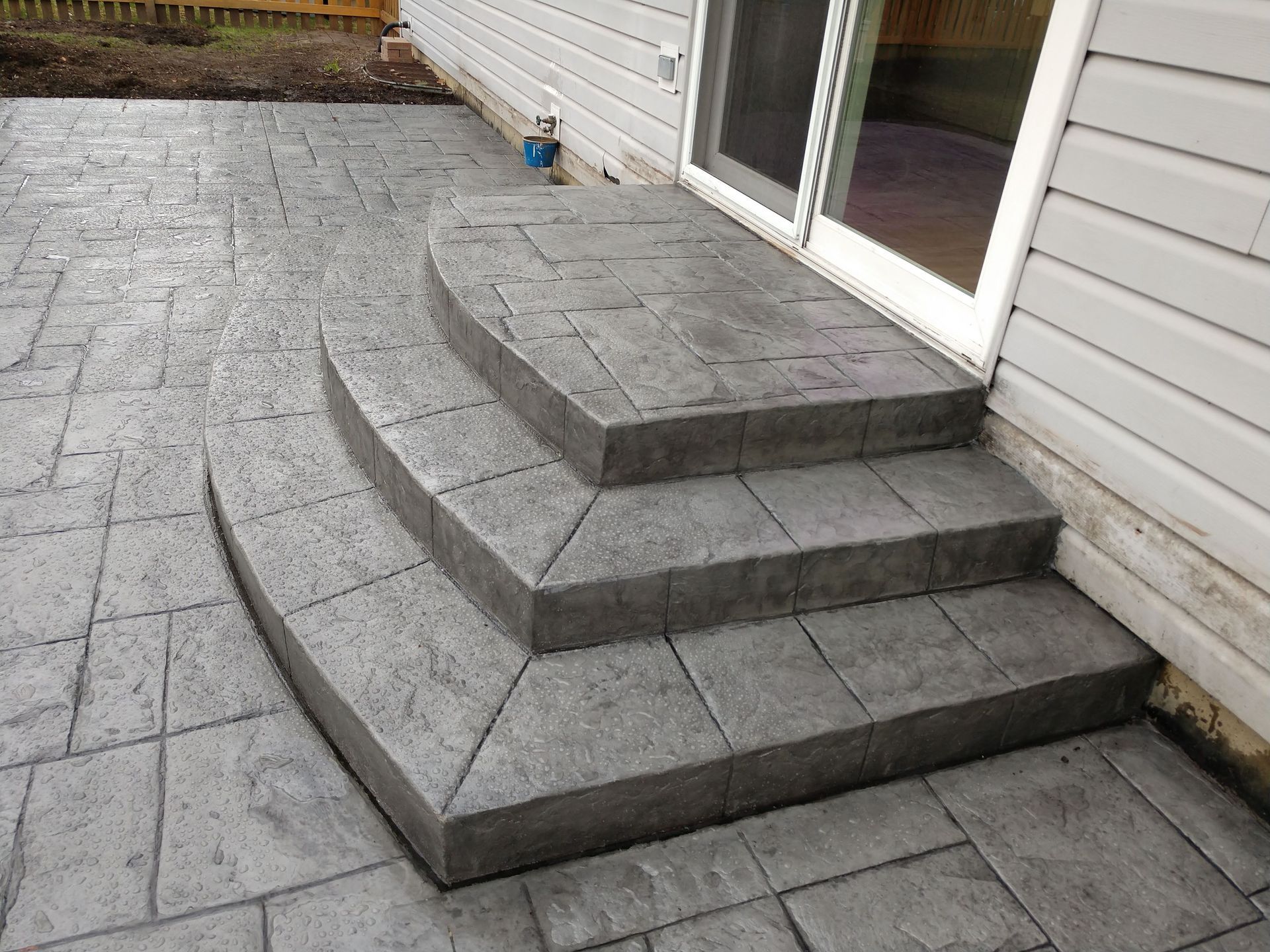 A set of concrete steps leading up to a house.