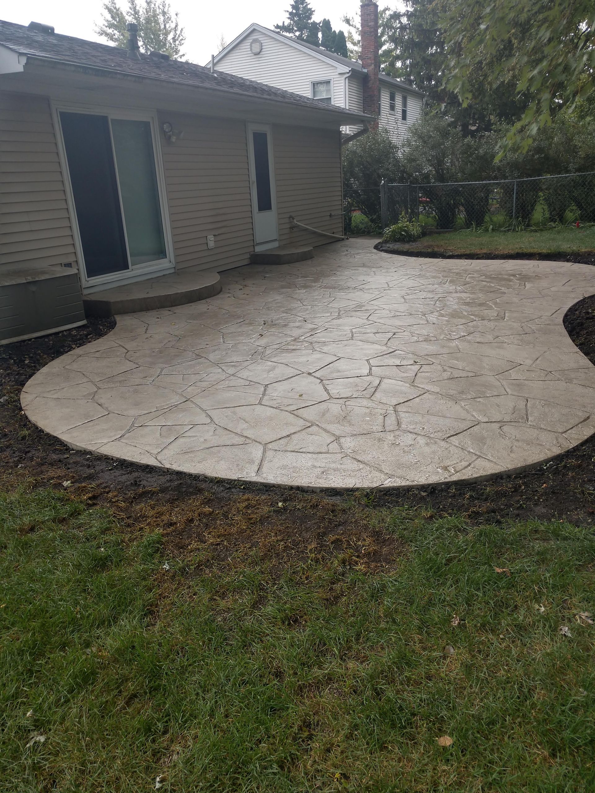 There is a concrete patio in front of a house.