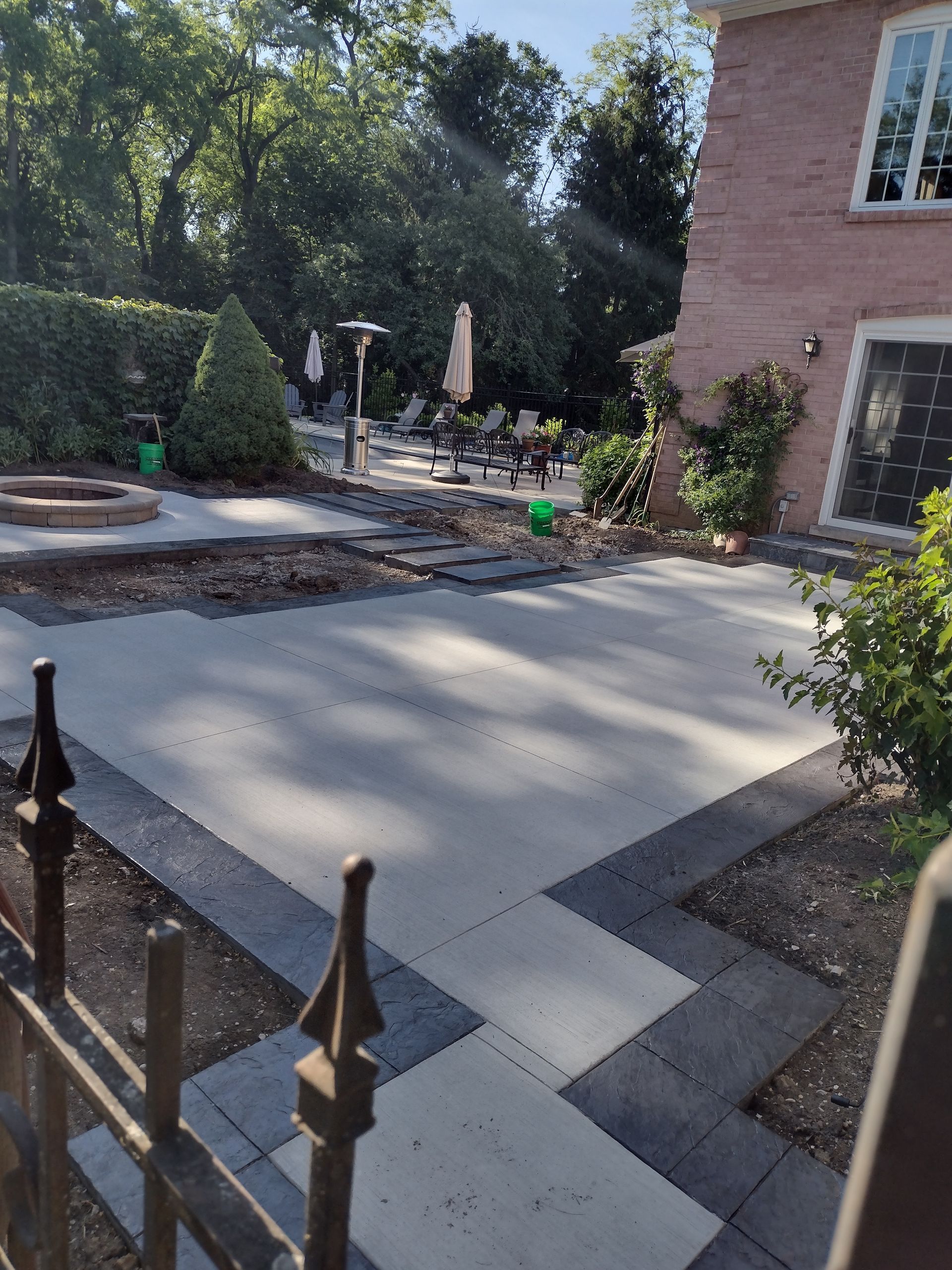 A brick house with a patio and a fire pit in front of it.