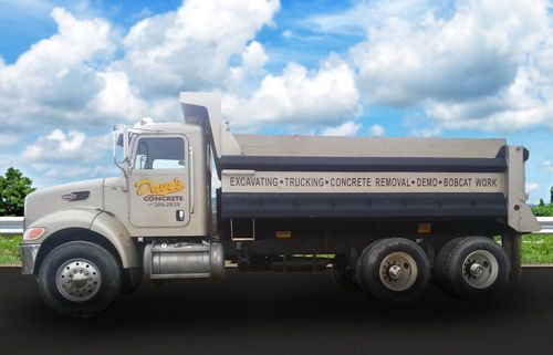 A dump truck is parked on the side of the road.