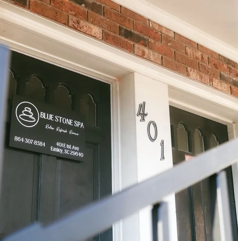 Blue Stone Spa storefront with dark green doors, white trim, and the number 401