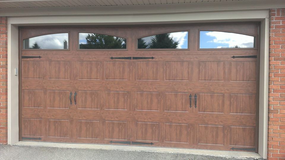 A car is parked in a garage with the door open